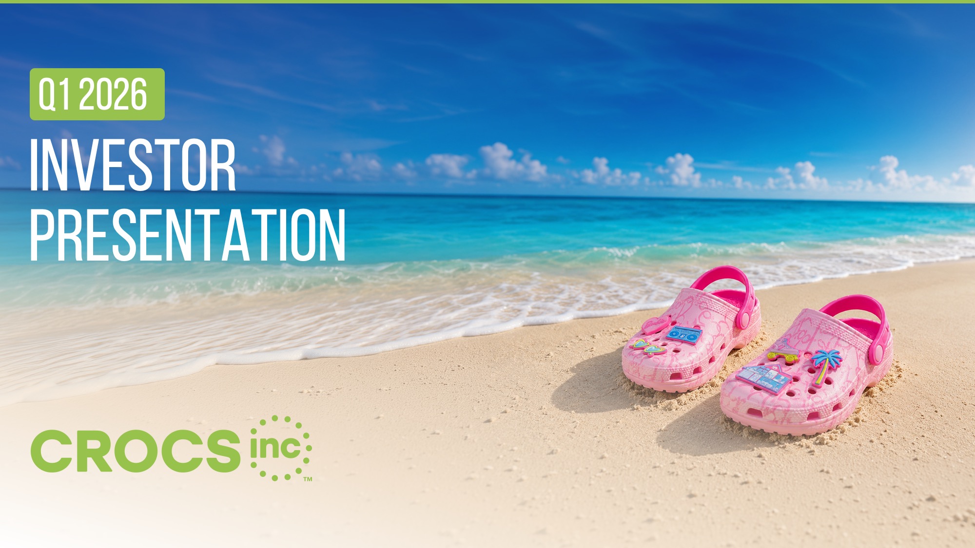 After Redesigned Crocs Q1 2026 Investor Presentation cover slide using a full-bleed beach photograph of a pair of pink Crocs clogs resting on sand at the water's edge under a bright blue sky, with large white display type reading "Q1 2026 Investor Presentation" in the upper-left corner, a green highlight block behind "Q1," and the Crocs Inc logo placed in green at the bottom left.