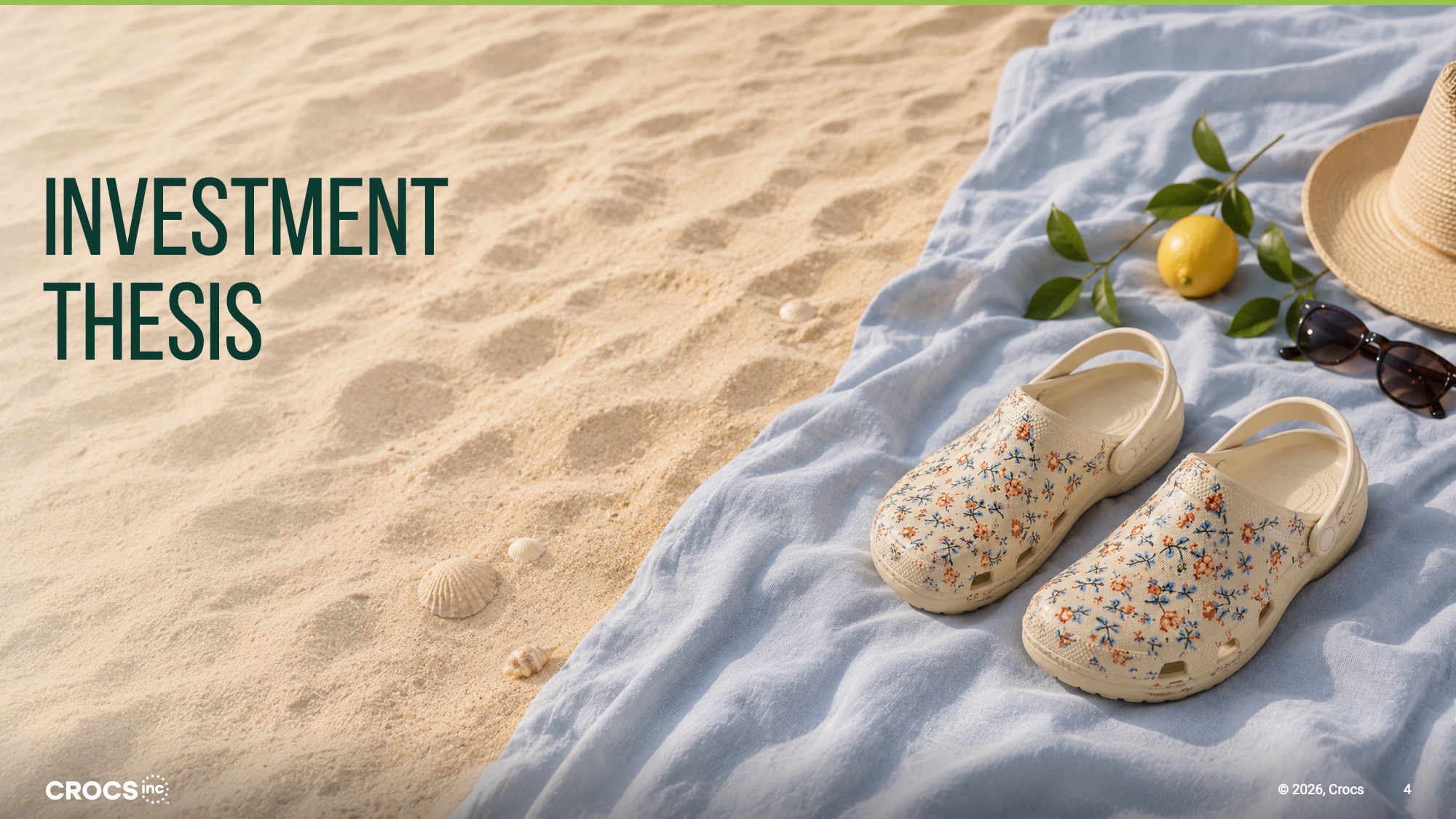 After Redesigned Investment Thesis section divider using a full-bleed beach and sand photograph showing a pair of white floral-print Crocs clogs resting on a blue linen cloth beside a lemon, sunglasses, and a straw hat, with "Investment Thesis" set in large dark forest-green type in the upper-left corner over the sandy area of the image.